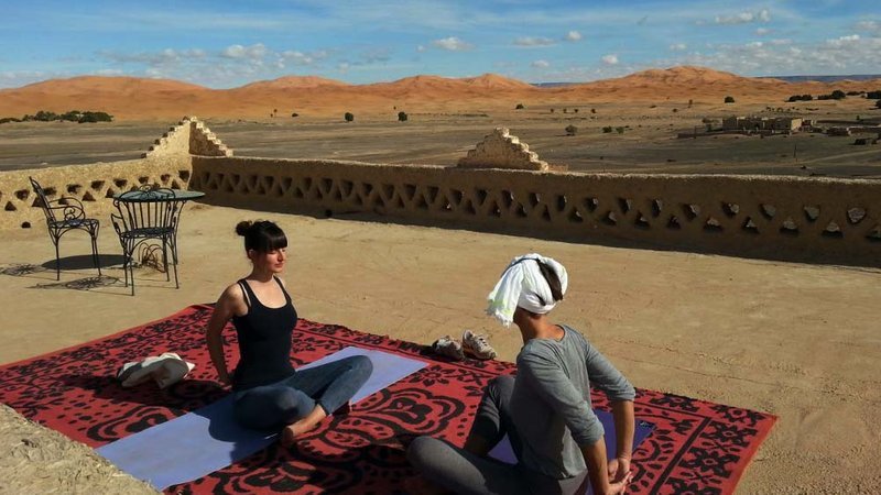 Group yoga session in Erg Chigaga desert camp